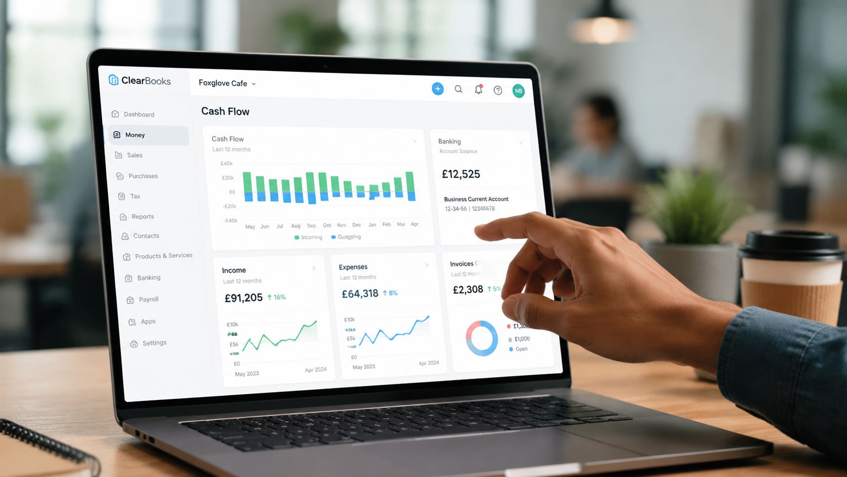 A professional using a laptop to view a financial dashboard on the ClearBooks accounting software platform.