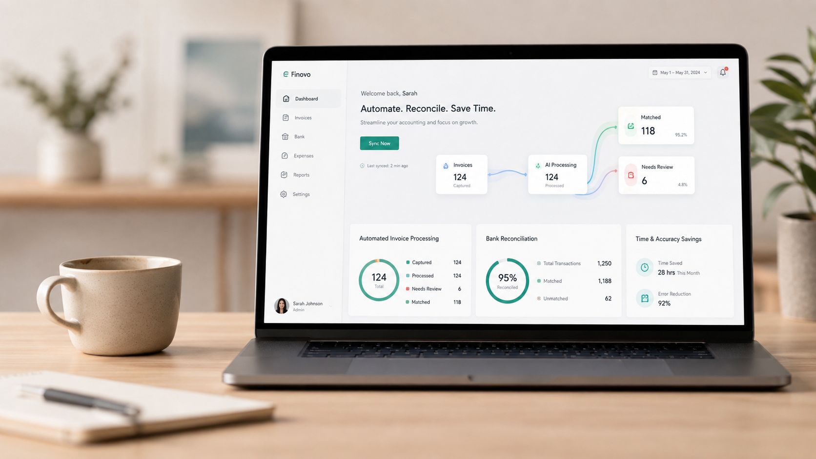 A modern laptop displaying an accounting software dashboard on a wooden desk with a cup of coffee.